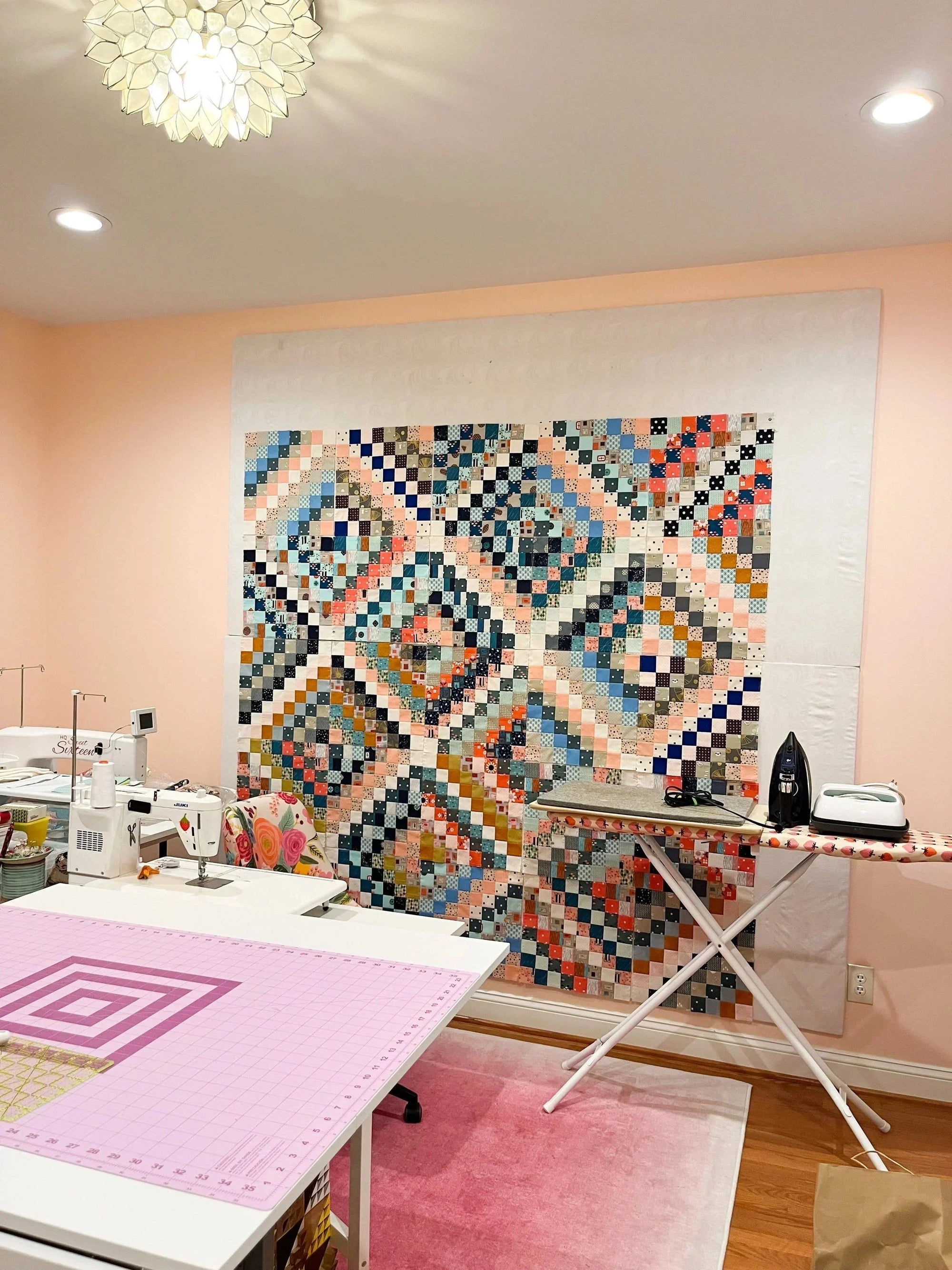 scrappy trip around the world quilt on a design wall