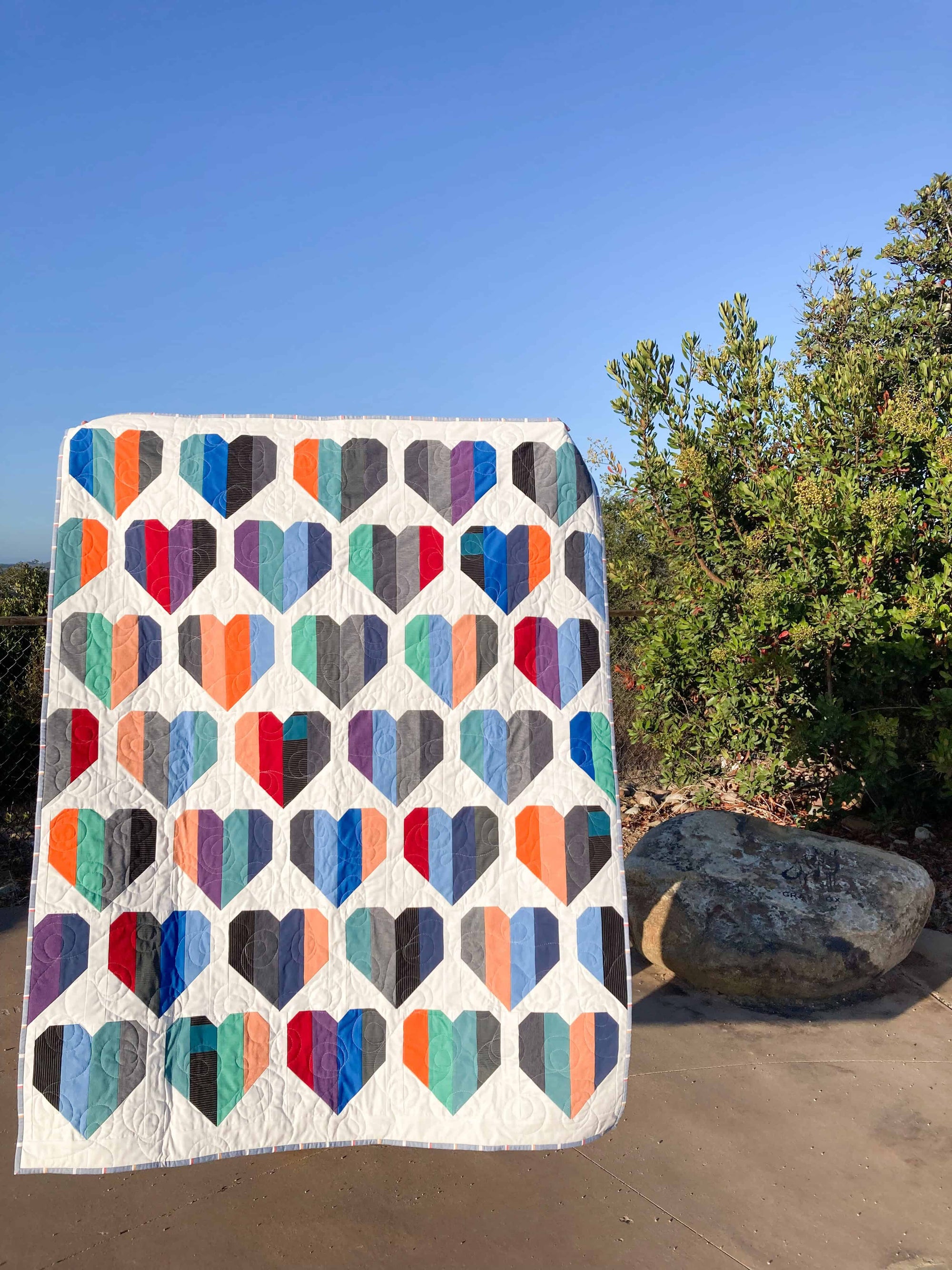 Colorful memory quilt made from golf shirts in heart shapes