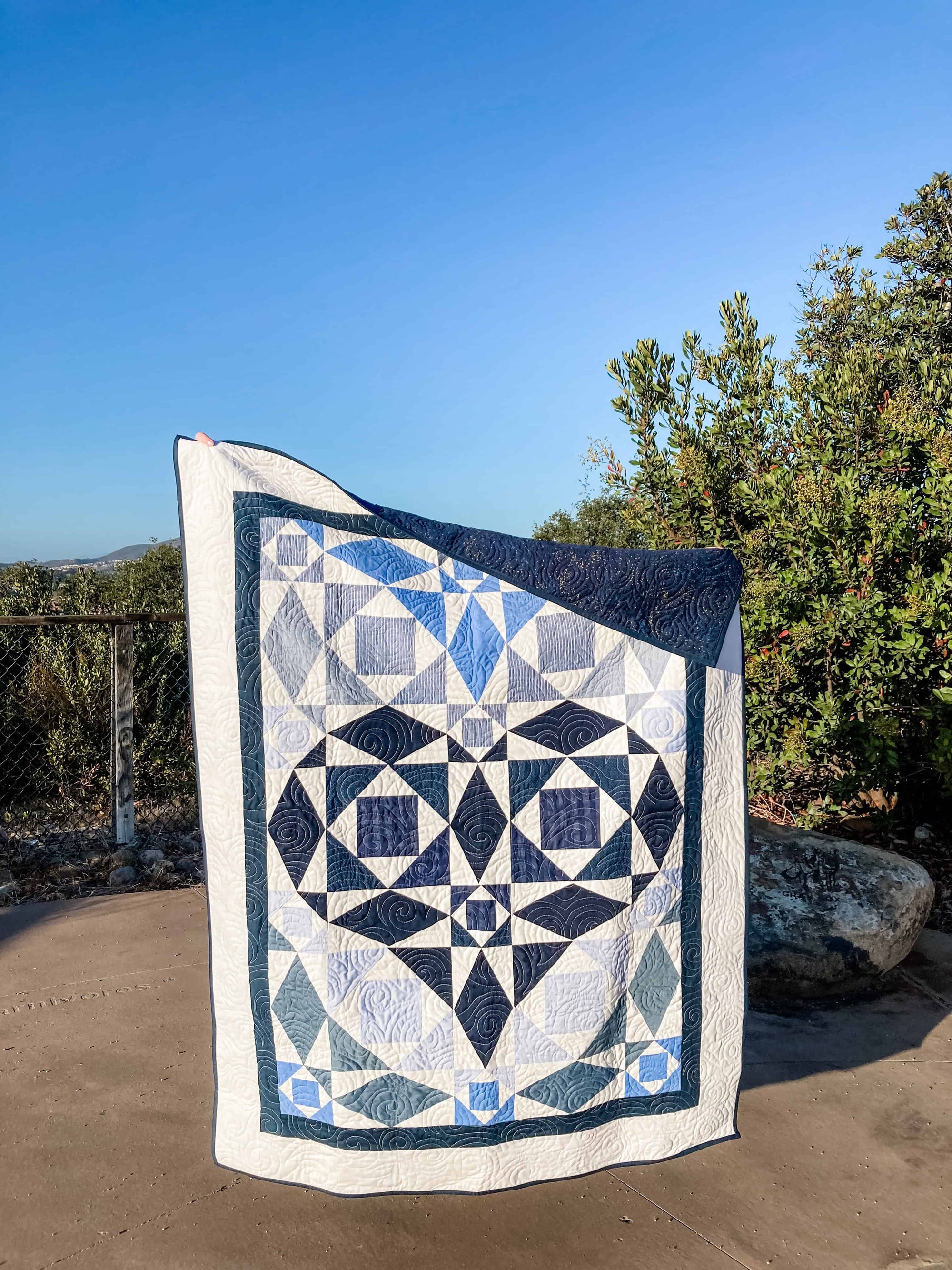blue quilt made from clothing in Storm At Sea geometric pattern with a heart shape incorporated