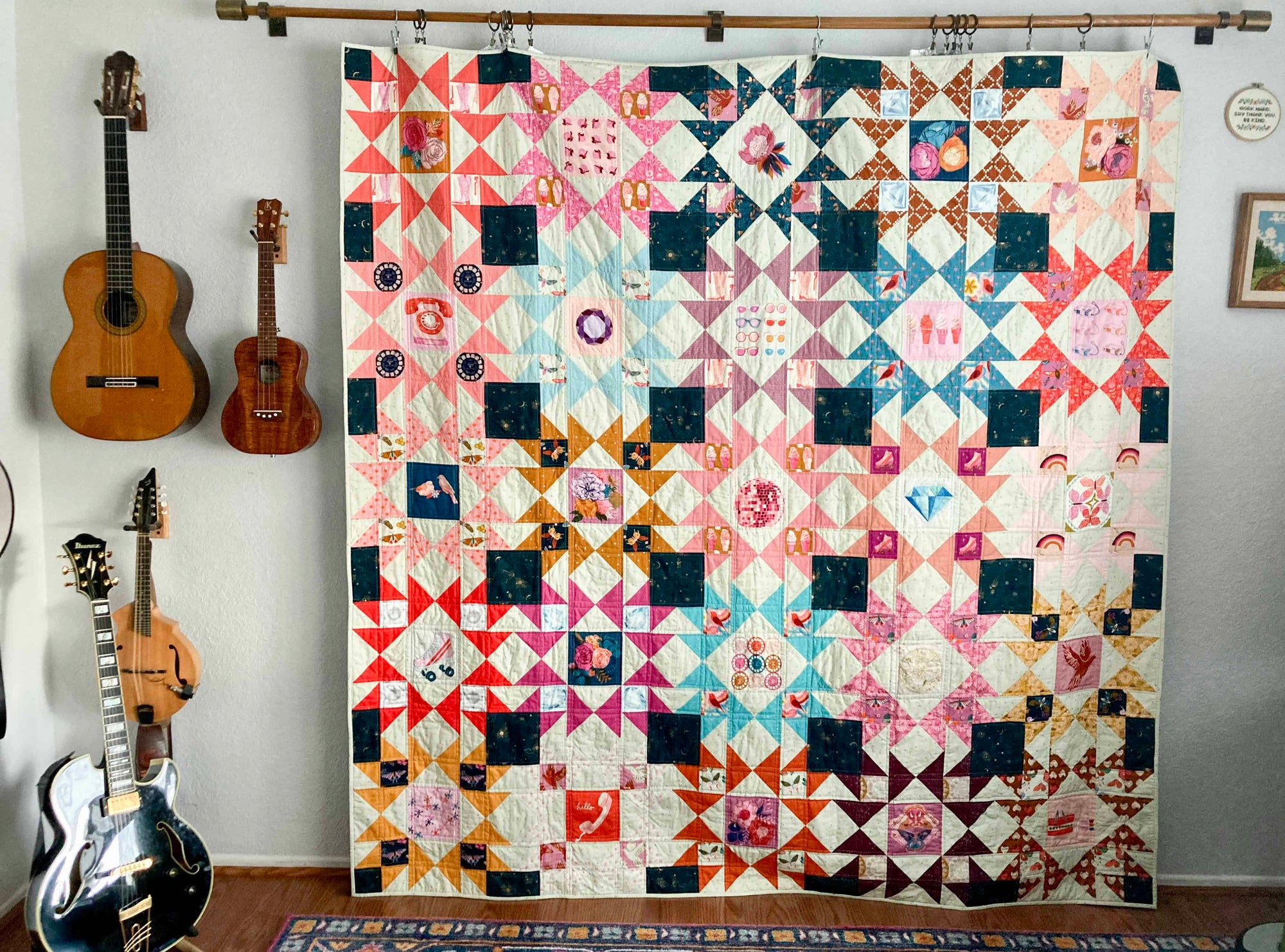 Patchwork quilt with star designs in Society quilt pattern hanging on a wall next to musical instruments